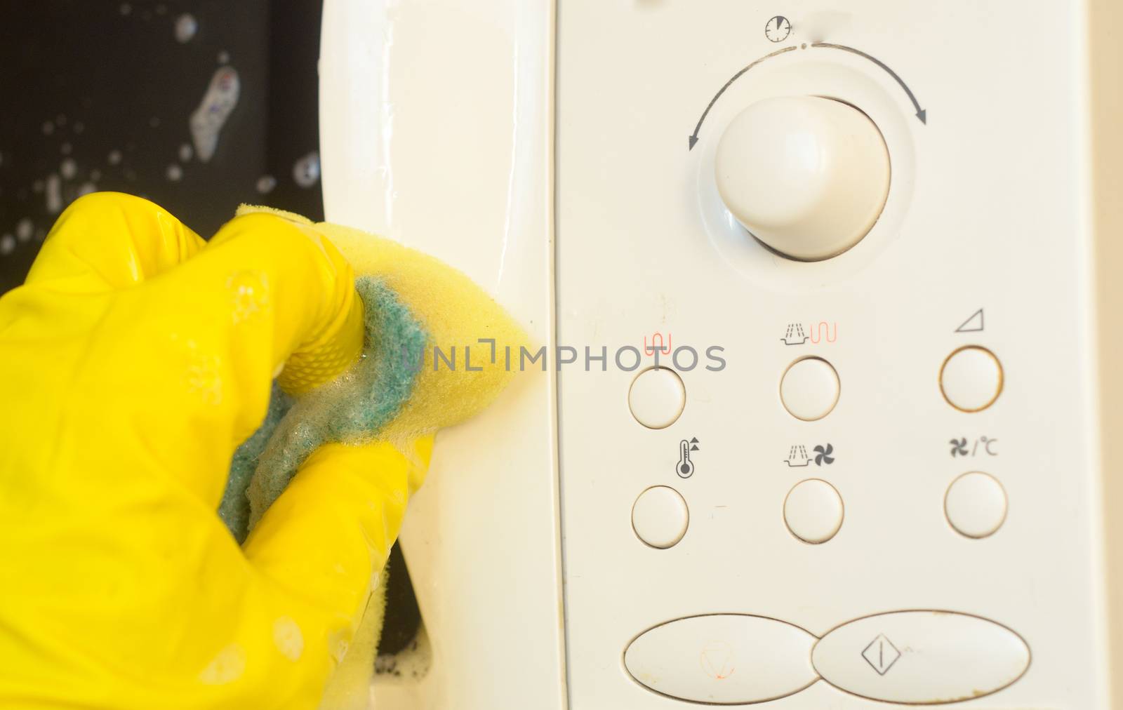 Microwave oven washing using a detergent solution with foam,closeup. by andre_dechapelle