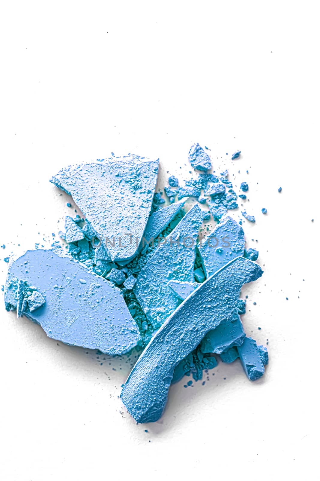 Blue eye shadow powder as makeup palette closeup isolated on white background, crushed cosmetics and beauty textures