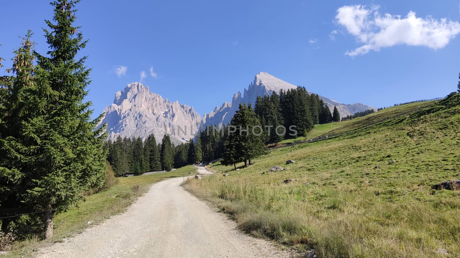 Val Gardena, Italy - 09/15/2020: Scenic alpine place with magical Dolomites mountains in background, amazing clouds and blue sky in Trentino Alto Adige region, Italy, Europe