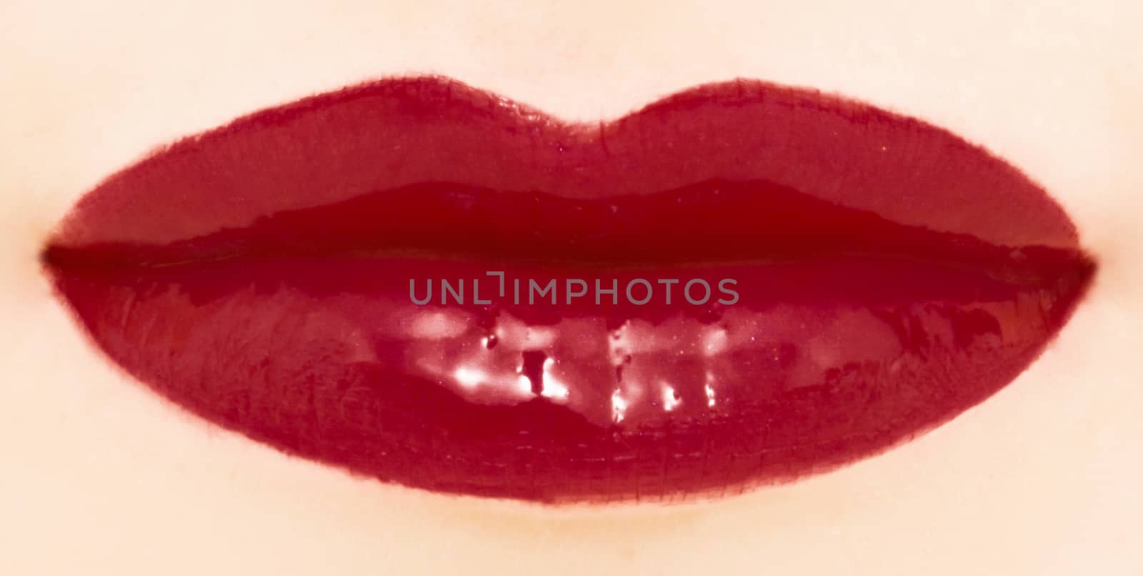 Female lips with glossy lipstick or lip gloss for make-up and beauty by Anneleven