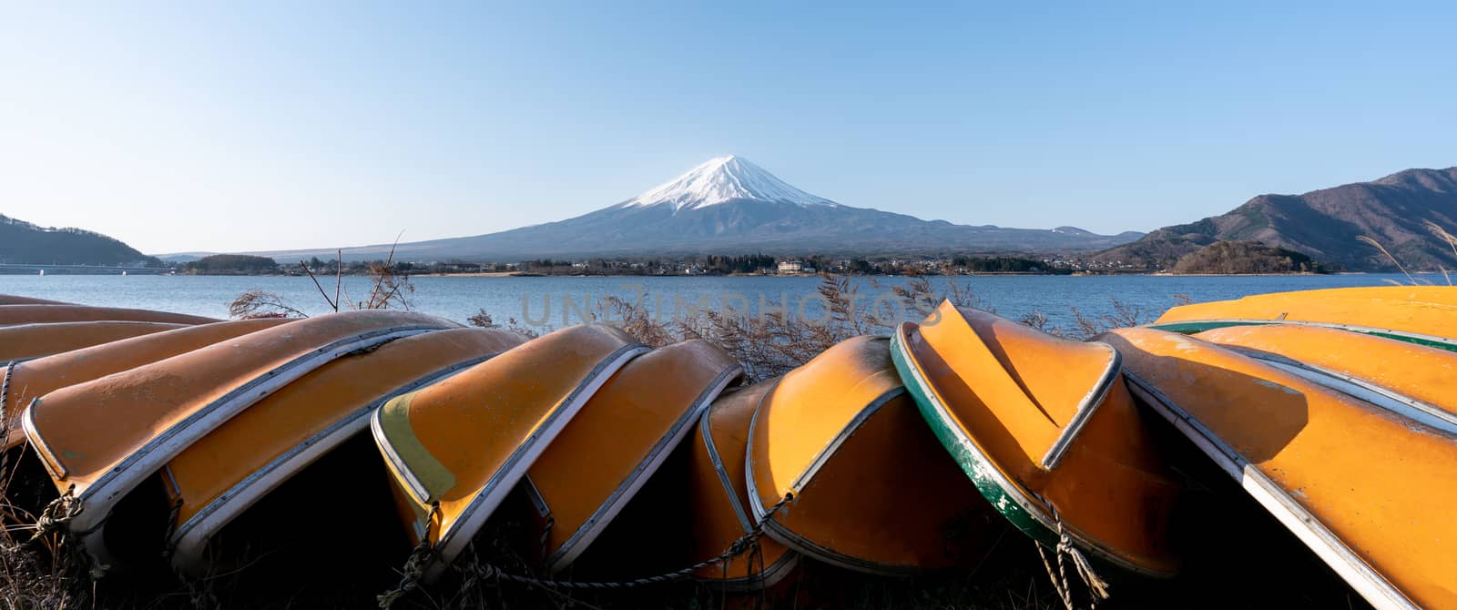 View of Mt. Fuji or Fuji-san with yellow boat and clear sky at lake kawaguchiko, Japan.