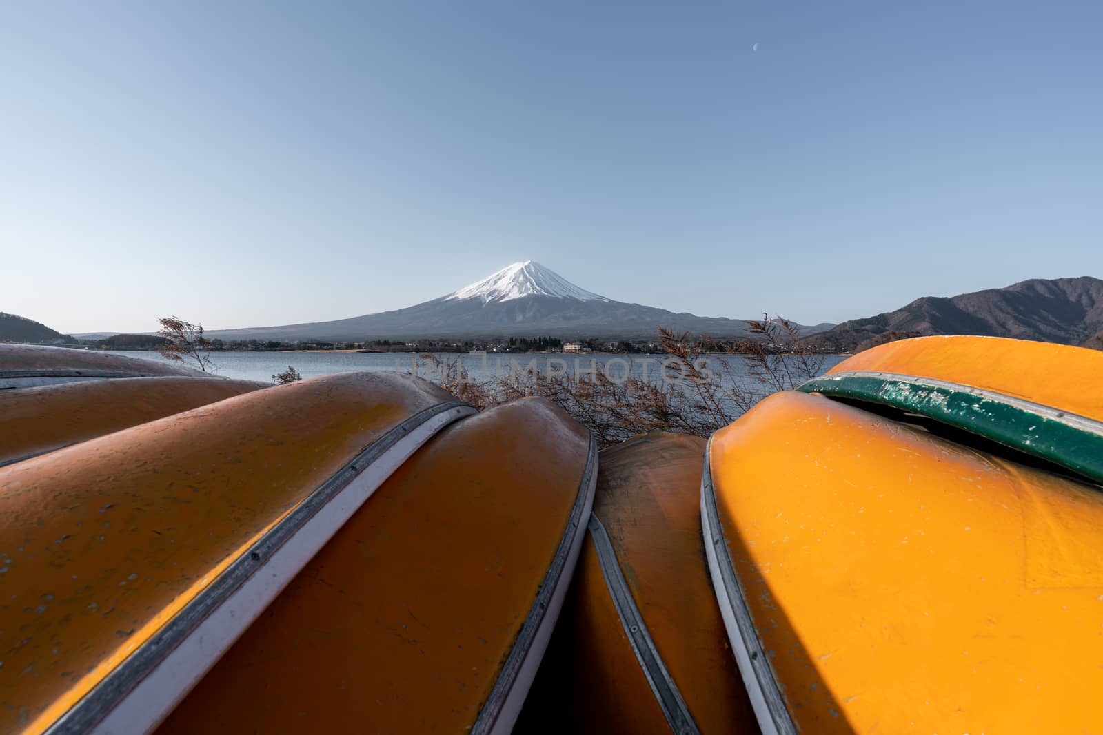 View of Mt. Fuji or Fuji-san with yellow boat and clear sky at lake kawaguchiko, Japan.