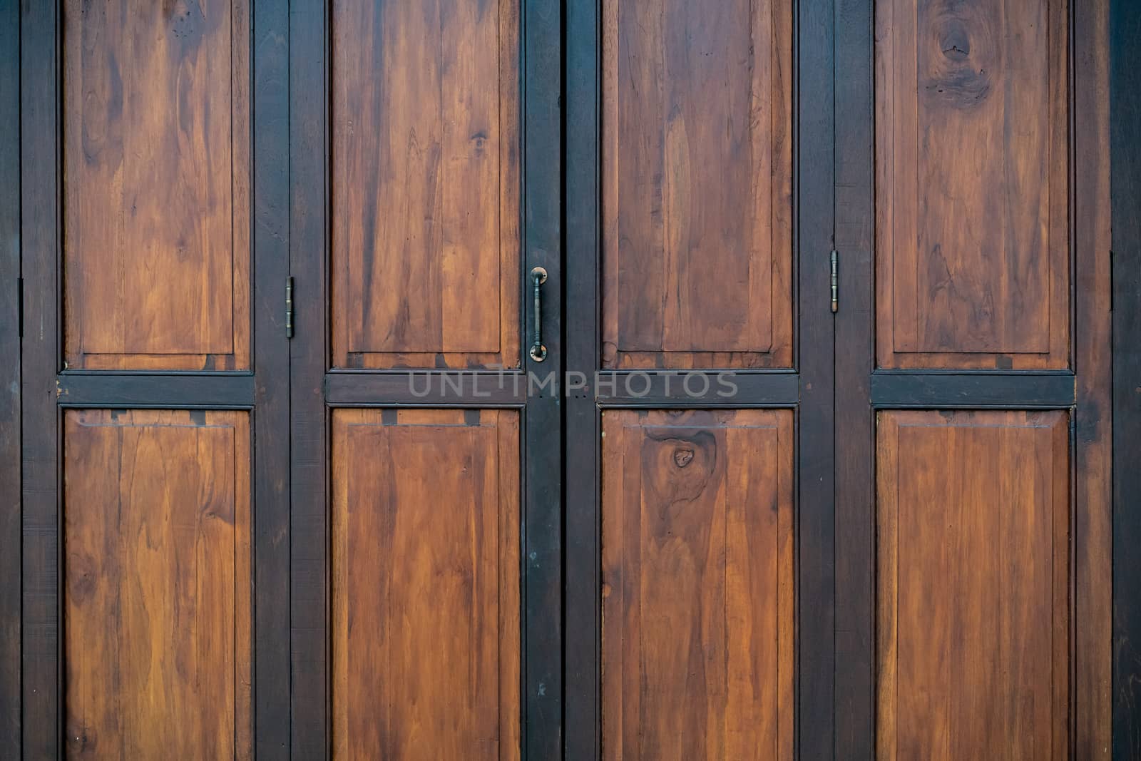 ฺBlack and brown old wooden folding doors.