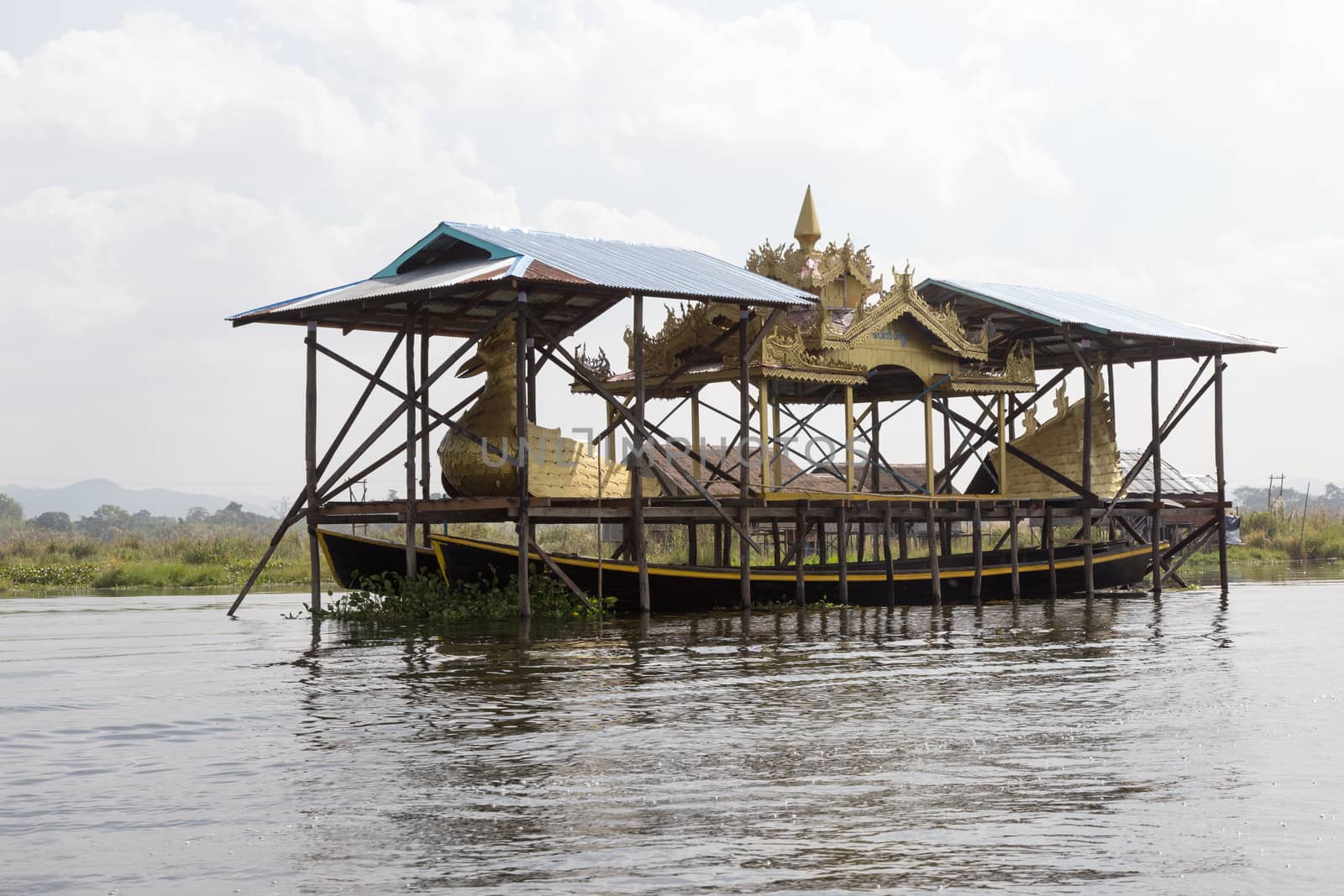 Inle Lake Myanmar 12/16/2015 with ceremonial boat under cover by kgboxford