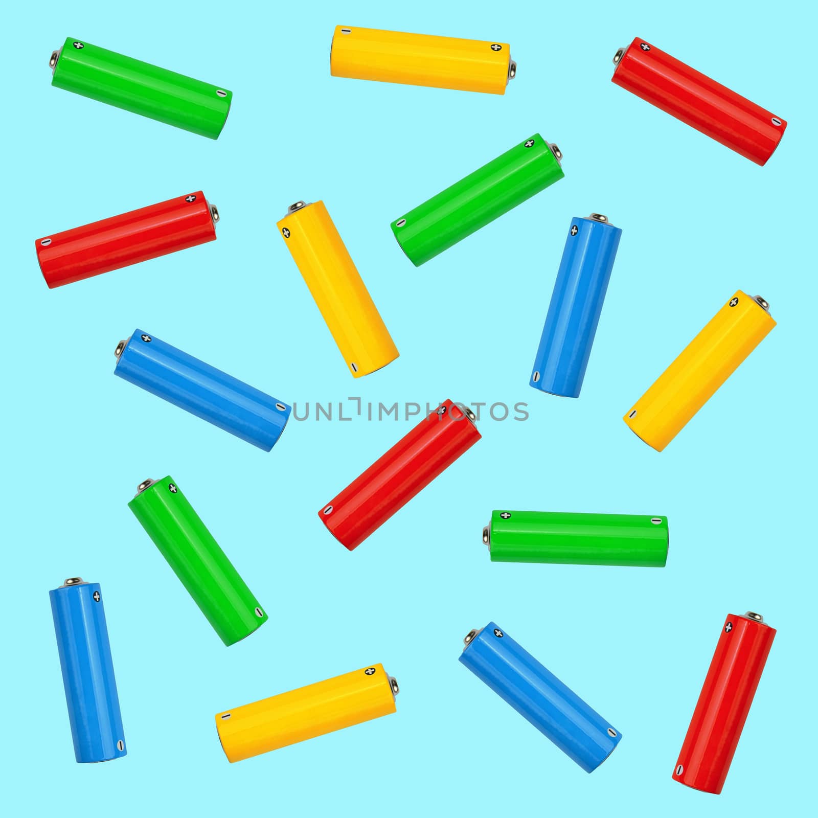Pattern of mixed multicolor alkaline AA batteries over blue background