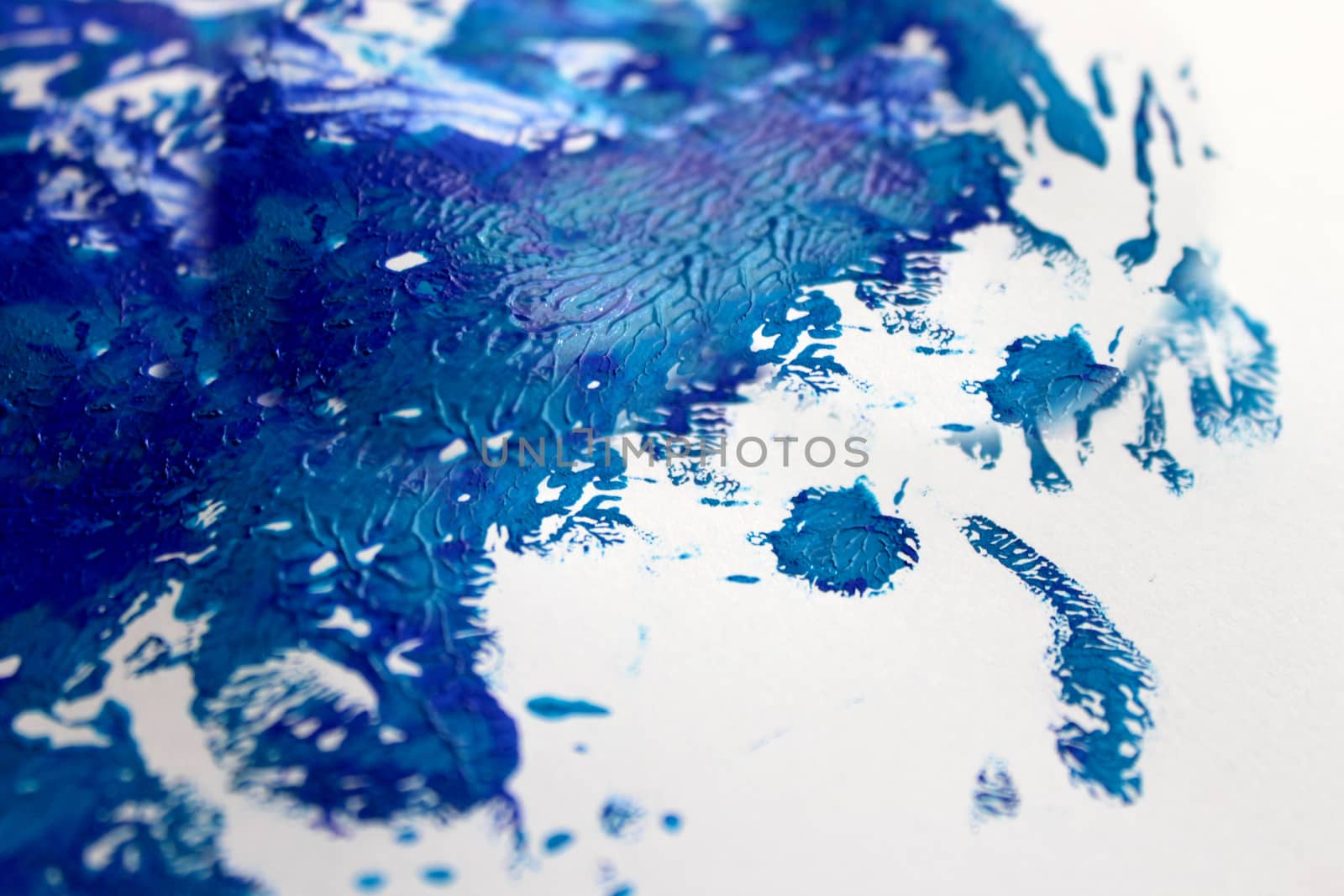 Strokes of blue paint on white paper background or texture
