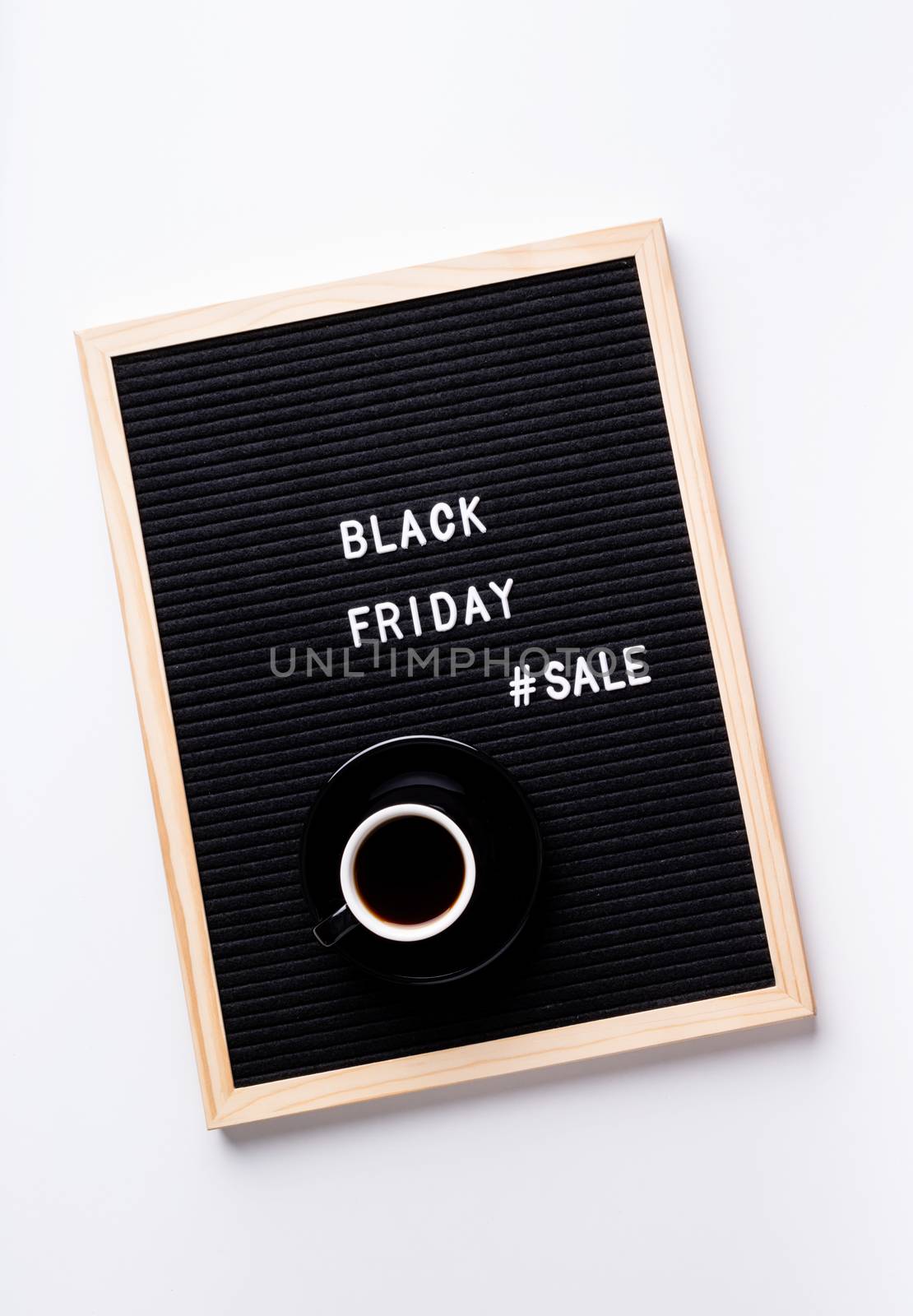 Black friday, seasonal sale concept. Text black friday sale on black letter board with cup of coffee on white background