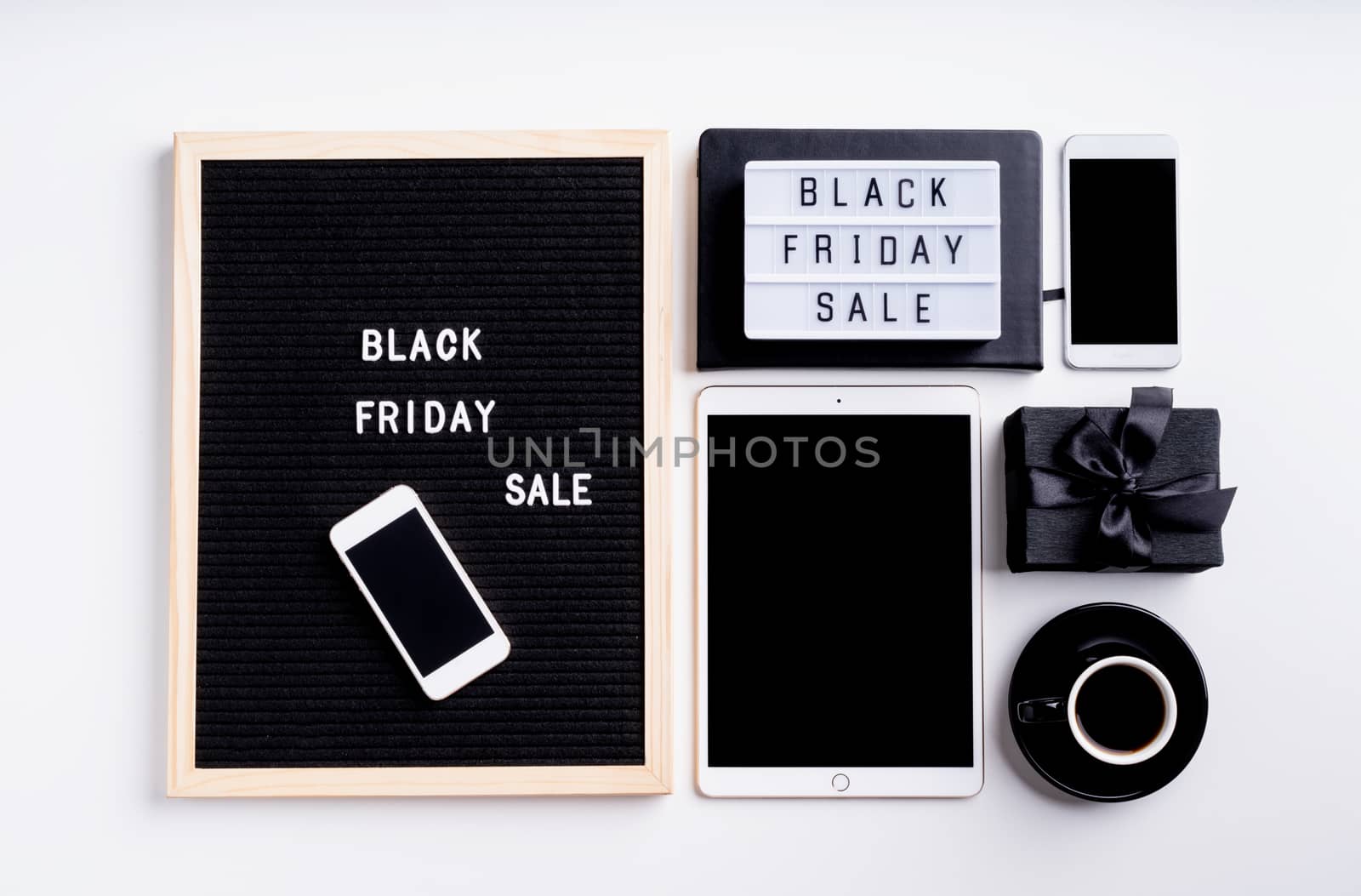 Text black friday sale on black letter board with cup of coffee, smarfphone, price tags on white background by Desperada