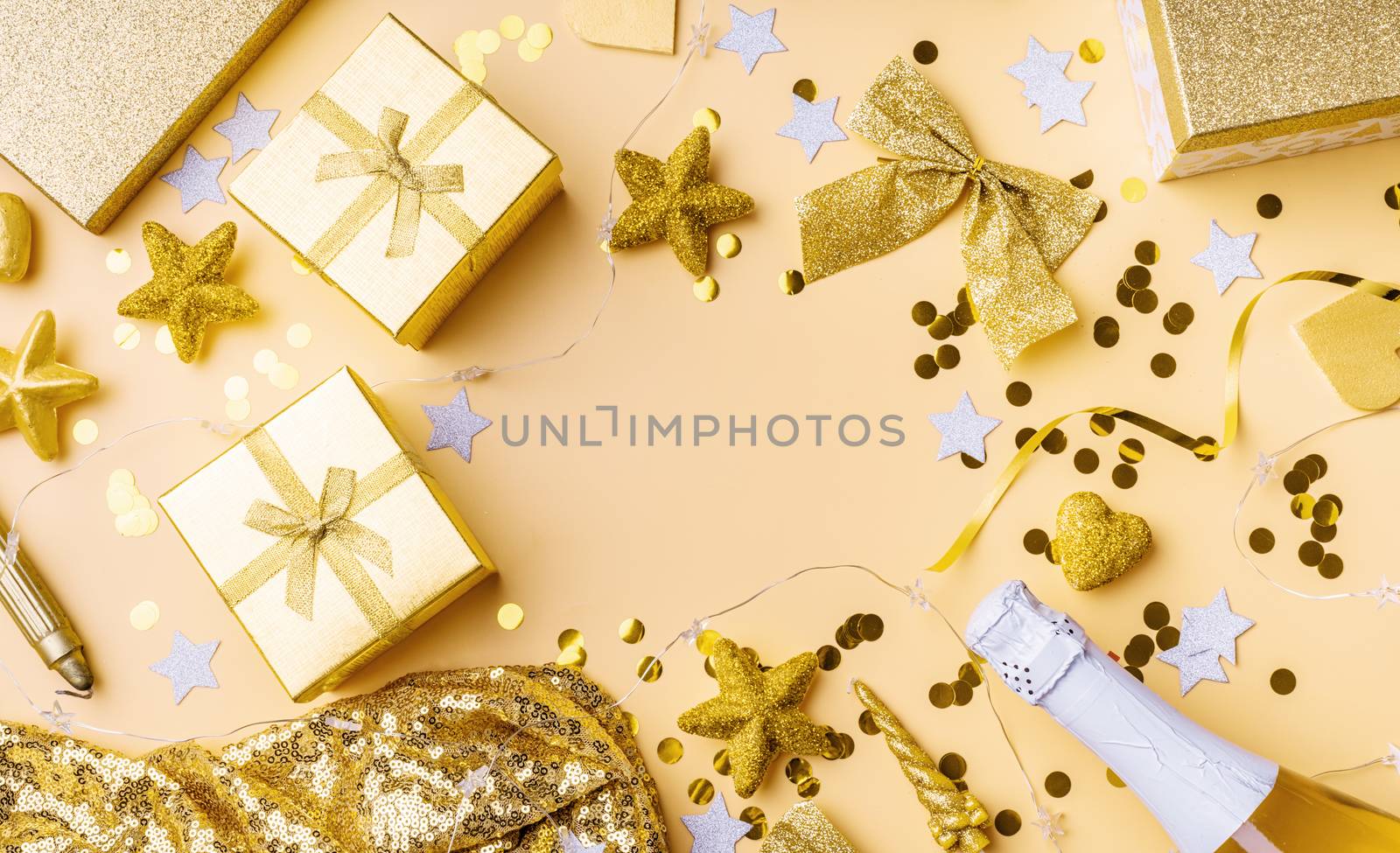 New Year and Christmas flat lay. Birthday party background. Top view of golden party decorations with confetti and gift boxes flat lay