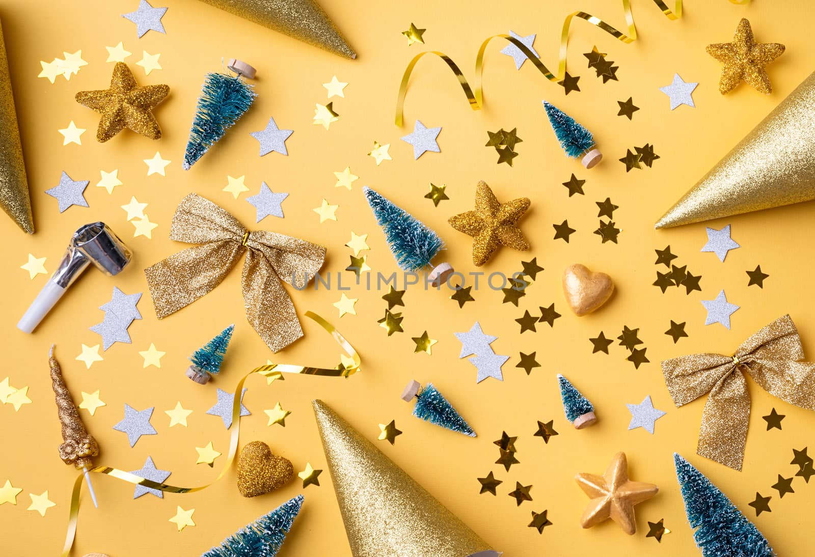 Top view of golden christmas and new year decorations with confetti and gift boxes flat lay by Desperada