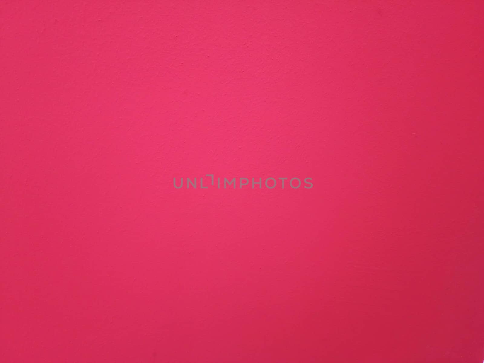 Crimson plaster wall. The background of painted wall.