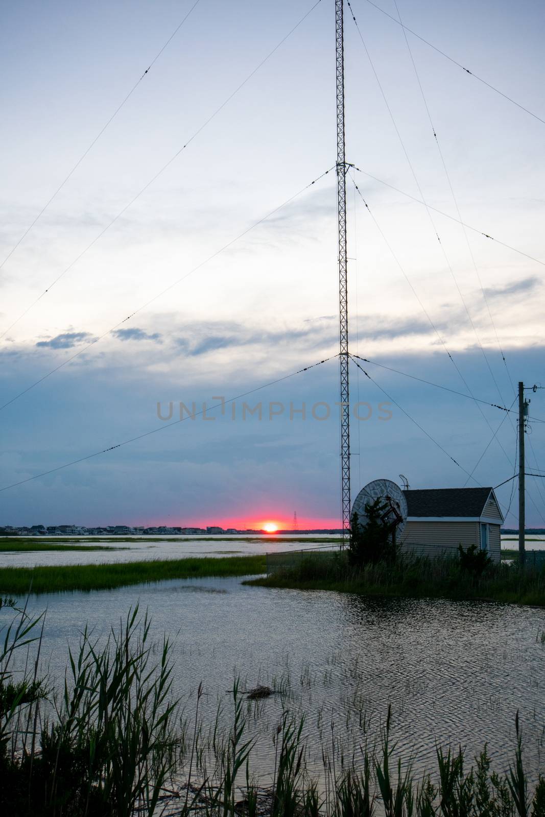 A Red Sunset Next to a Large Metal Radio Tower at the Bay in Wildwood New Jersey