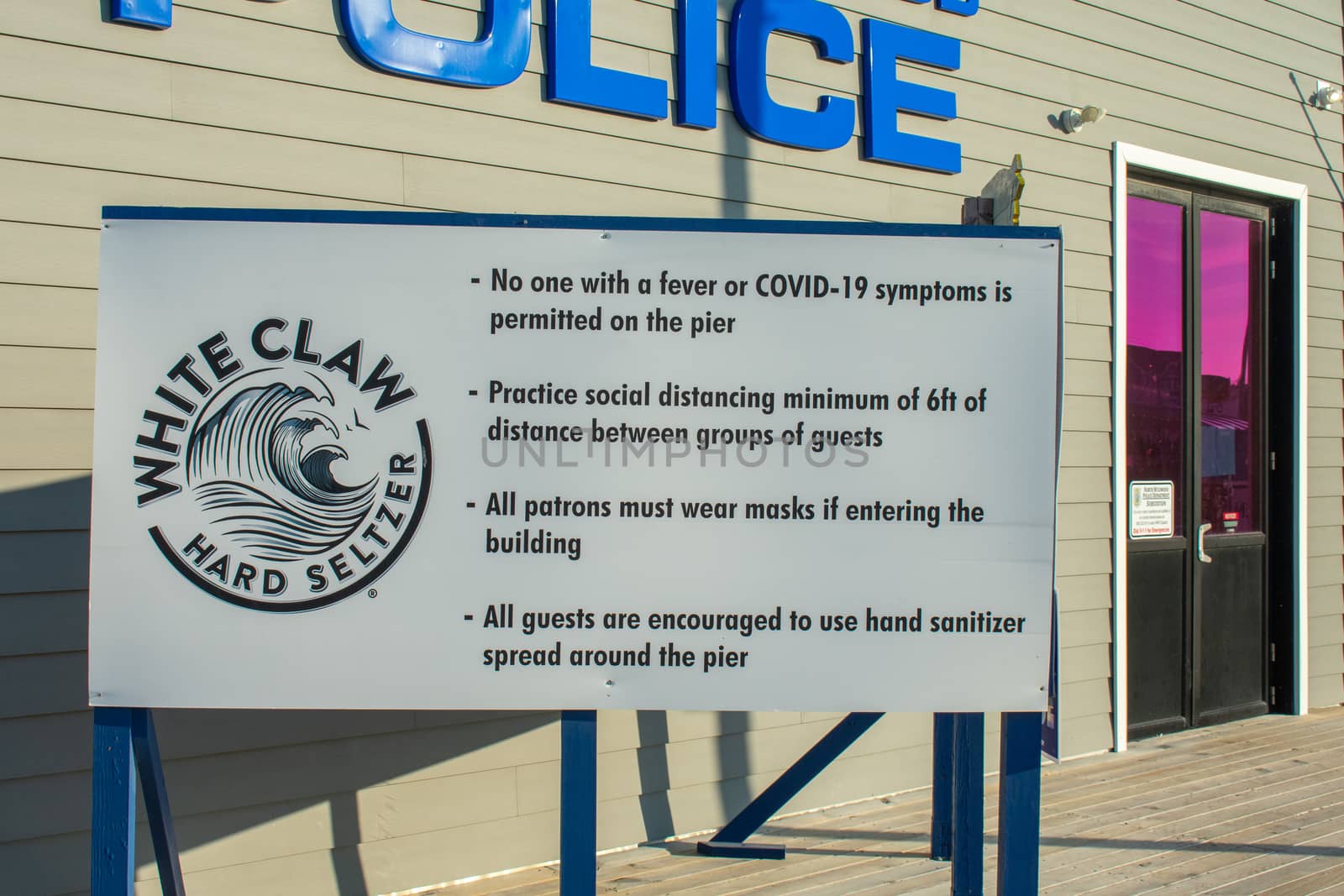 WILDWOOD, NEW JERSEY - AUGUST 8, 2018: A Sign on the Wildwood Boardwalk in Front of the Police Sation Stating Rules and Regulations During COVID-19