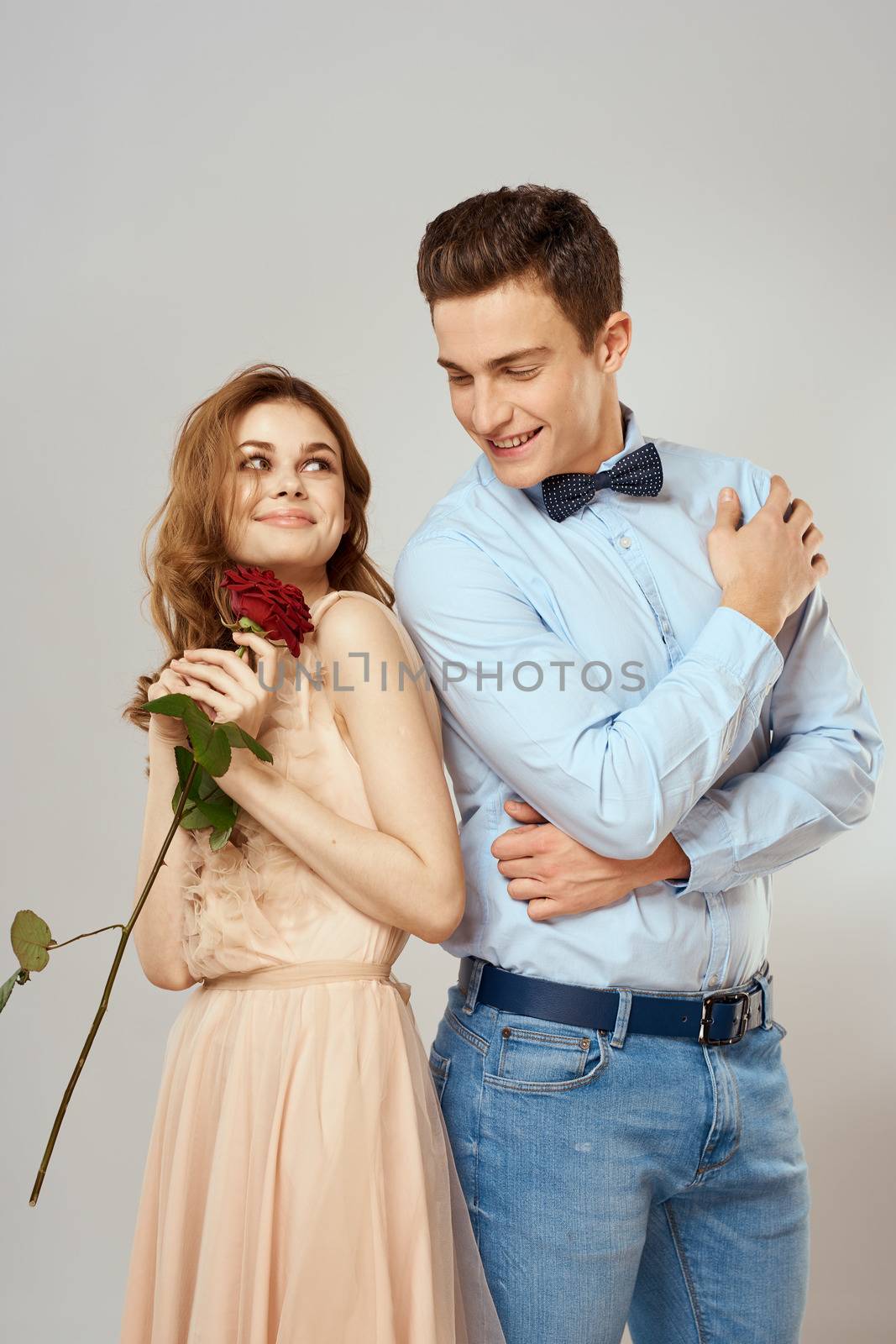 beautiful couple relationship rose gift as romance hug light background by SHOTPRIME