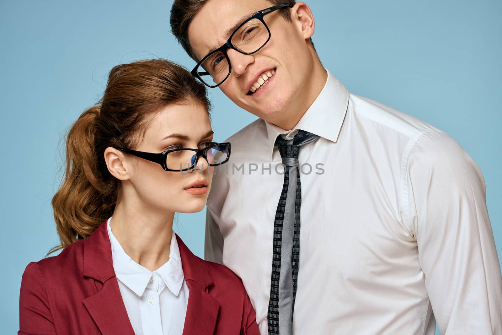 Business young couple officials office team office blue background. High quality photo