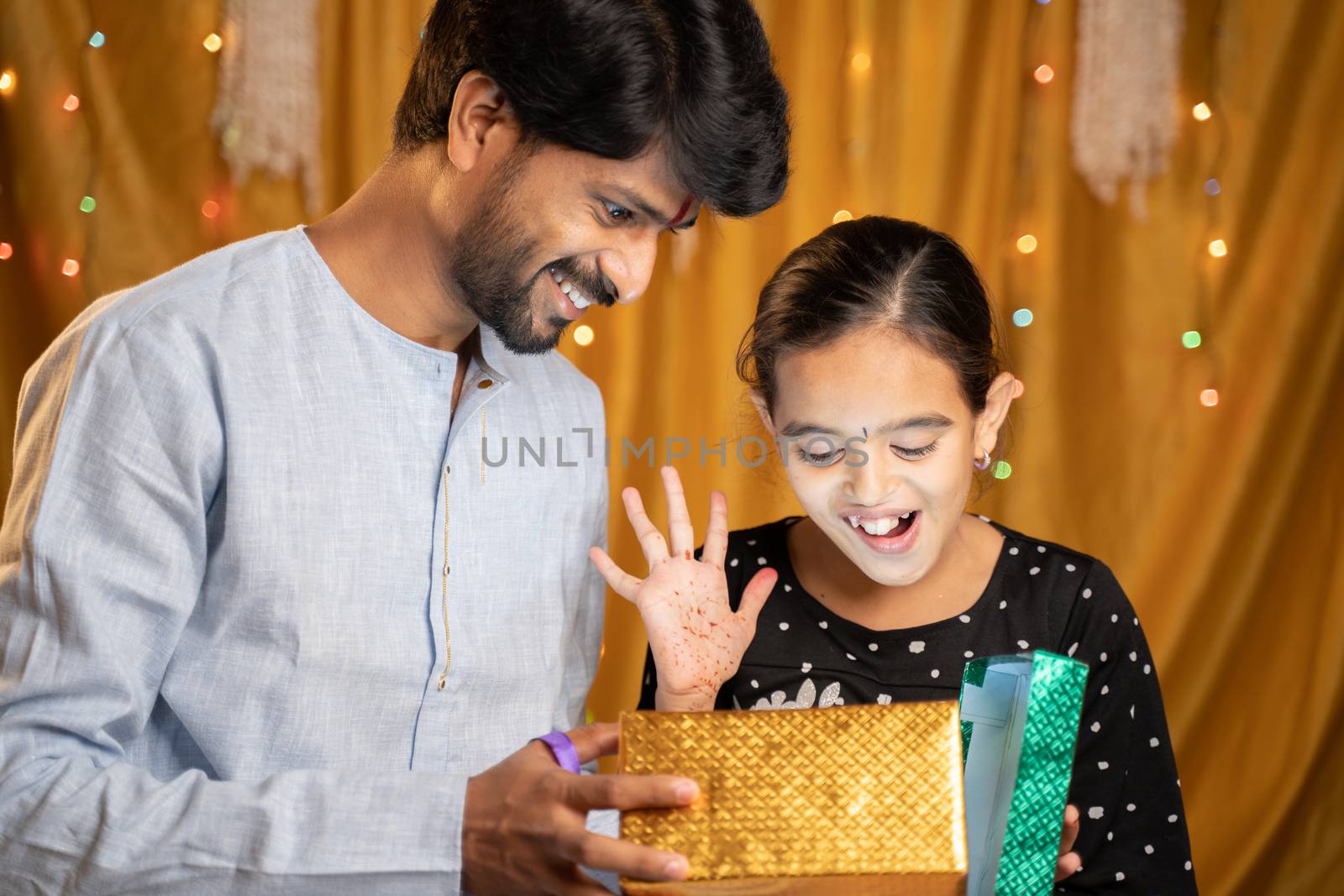 Excited little Siter got gift from her Bother during Raksha Bandhan, Bhai Dooj or Bhaubeej Indian religious festival ceremony