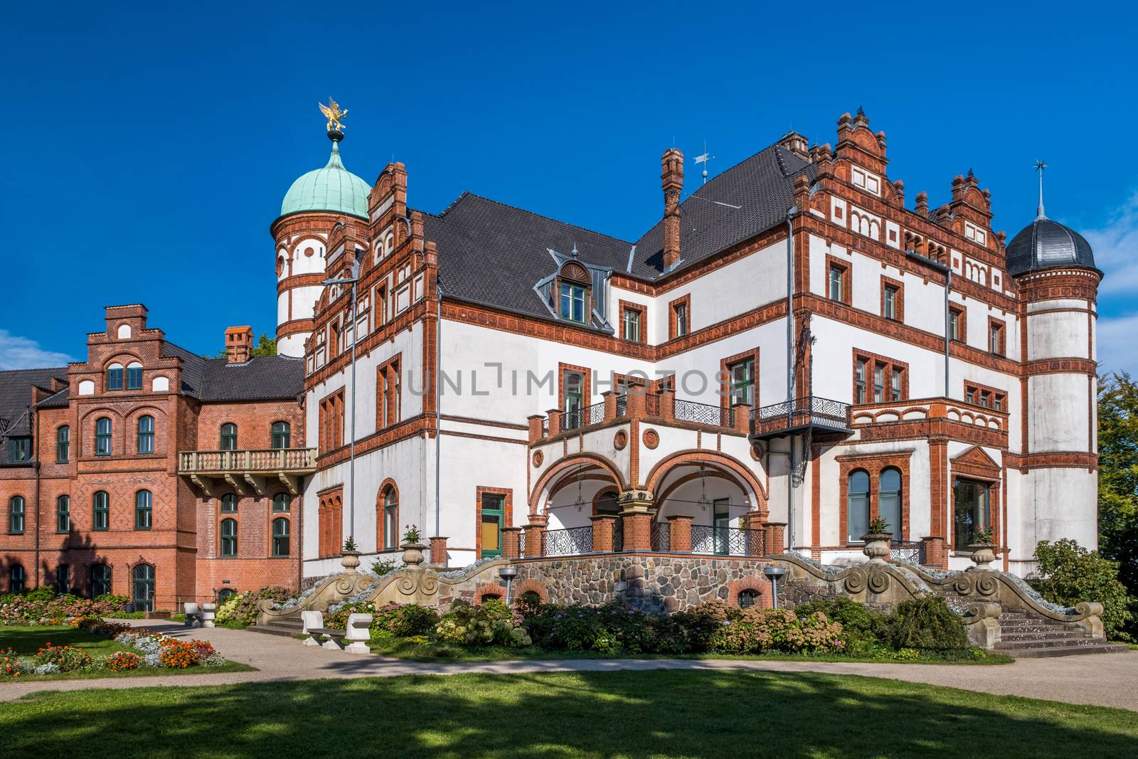 Beautiful fairytale castle of Wiligrad on a summer day by Fischeron