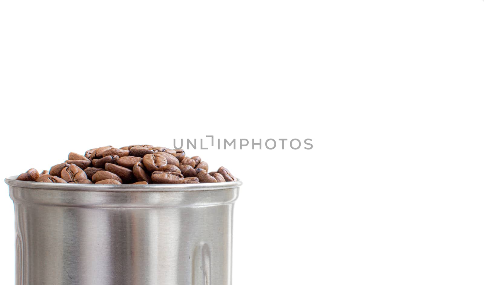 A lot of coffee beans in a metal coffee grinder on a white background. Isolated coffee items