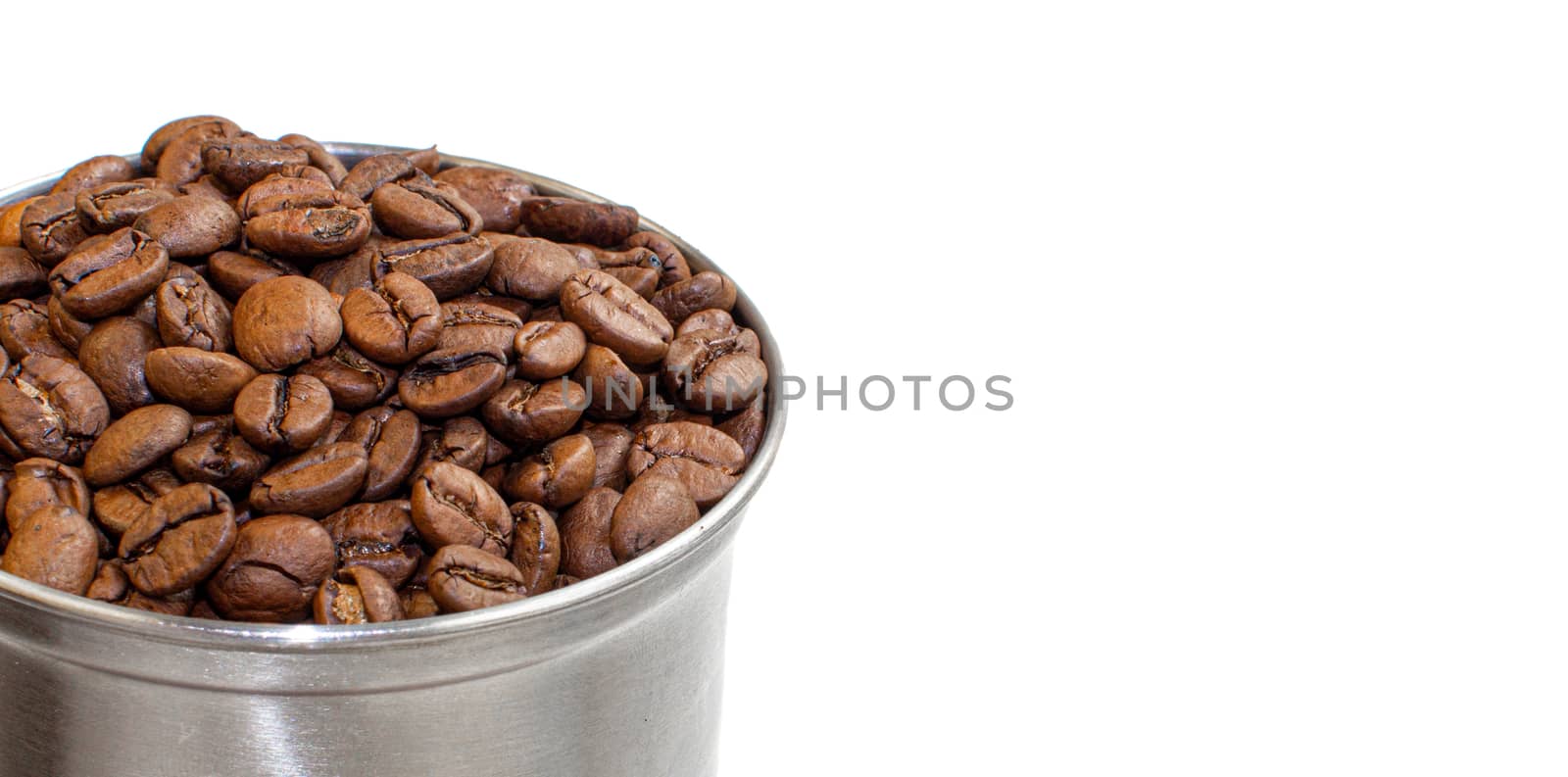 A lot of coffee beans in a metal coffee grinder on a white background. Isolated coffee items