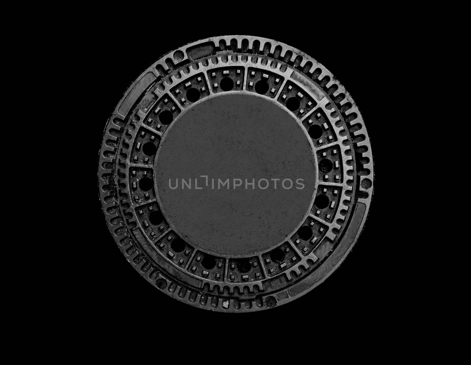 Old metal sewer manhole on a black background