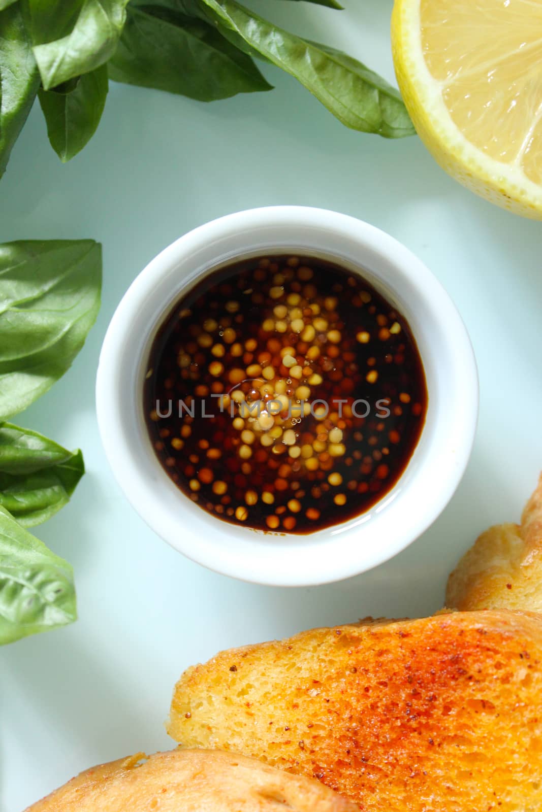 Sliced toasted French baguette with sauce and a slice of lemon.Texture or background