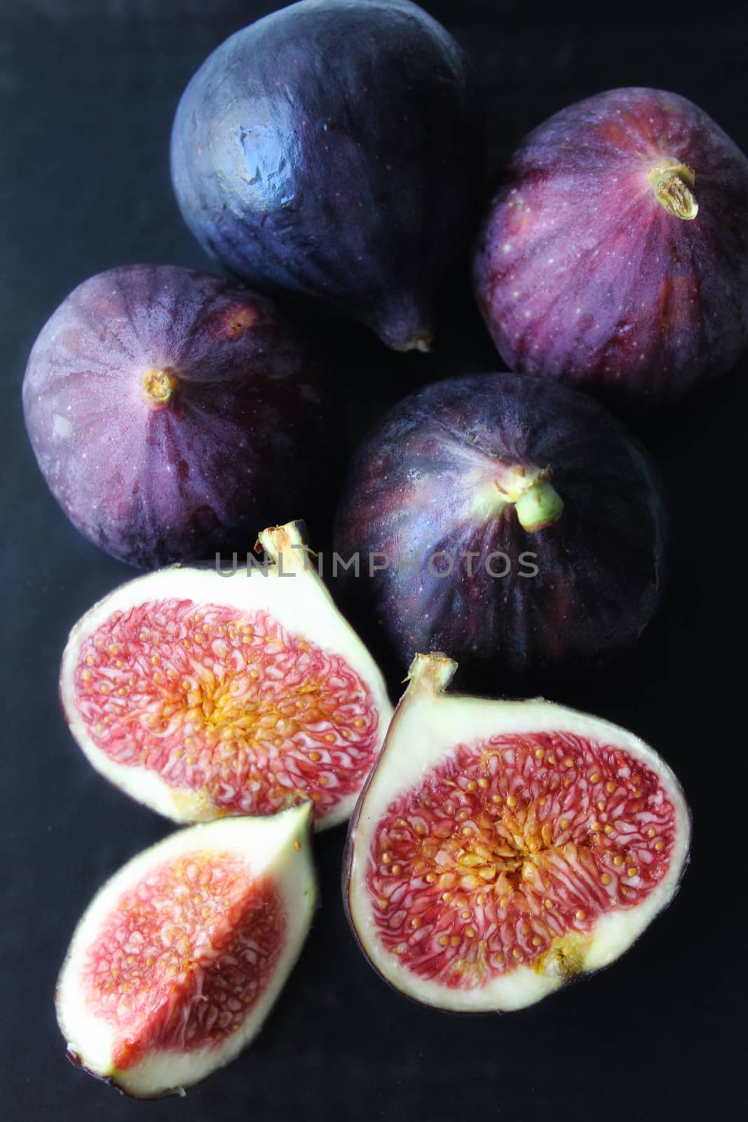 Purple figs on a dark background.Texture or background