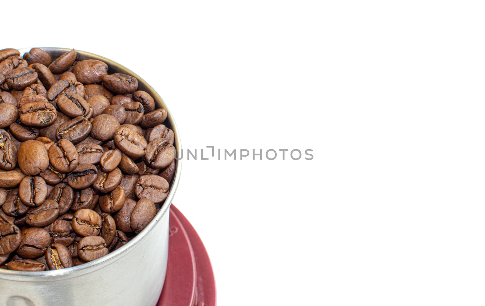 A lot of coffee beans in a metal coffee grinder on a white background. Isolated coffee items