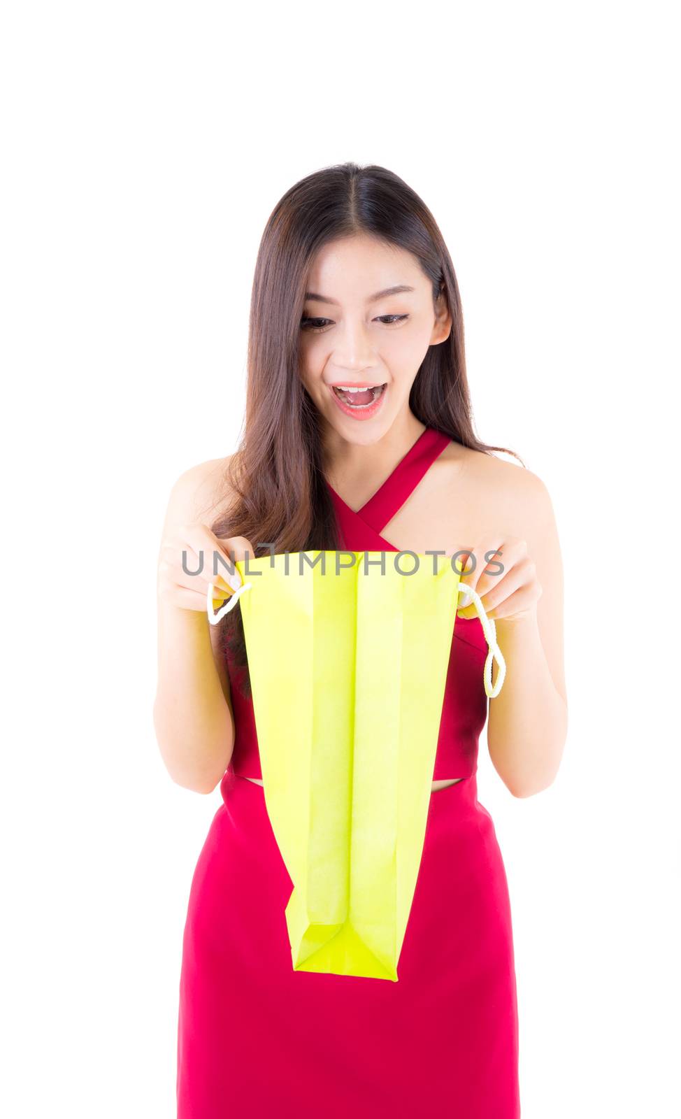 Happy asian woman opening paper bag, female is looking a shopping bag, isolated on white background.