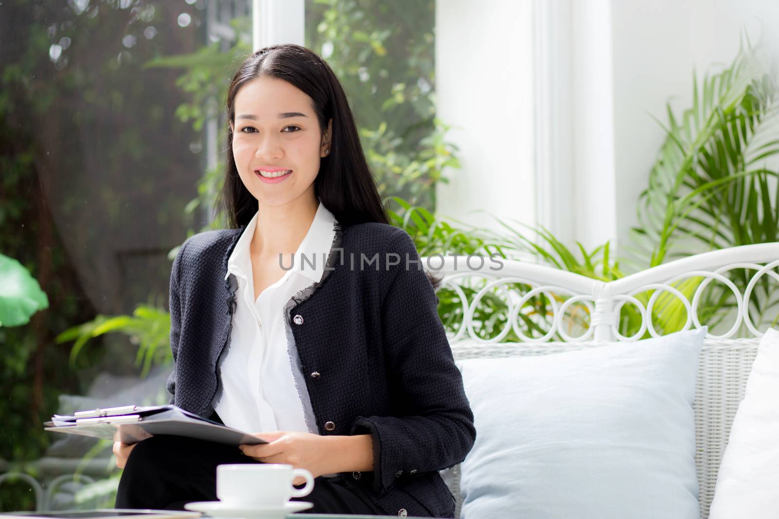 Asian business woman holding clipboard folder in the office.