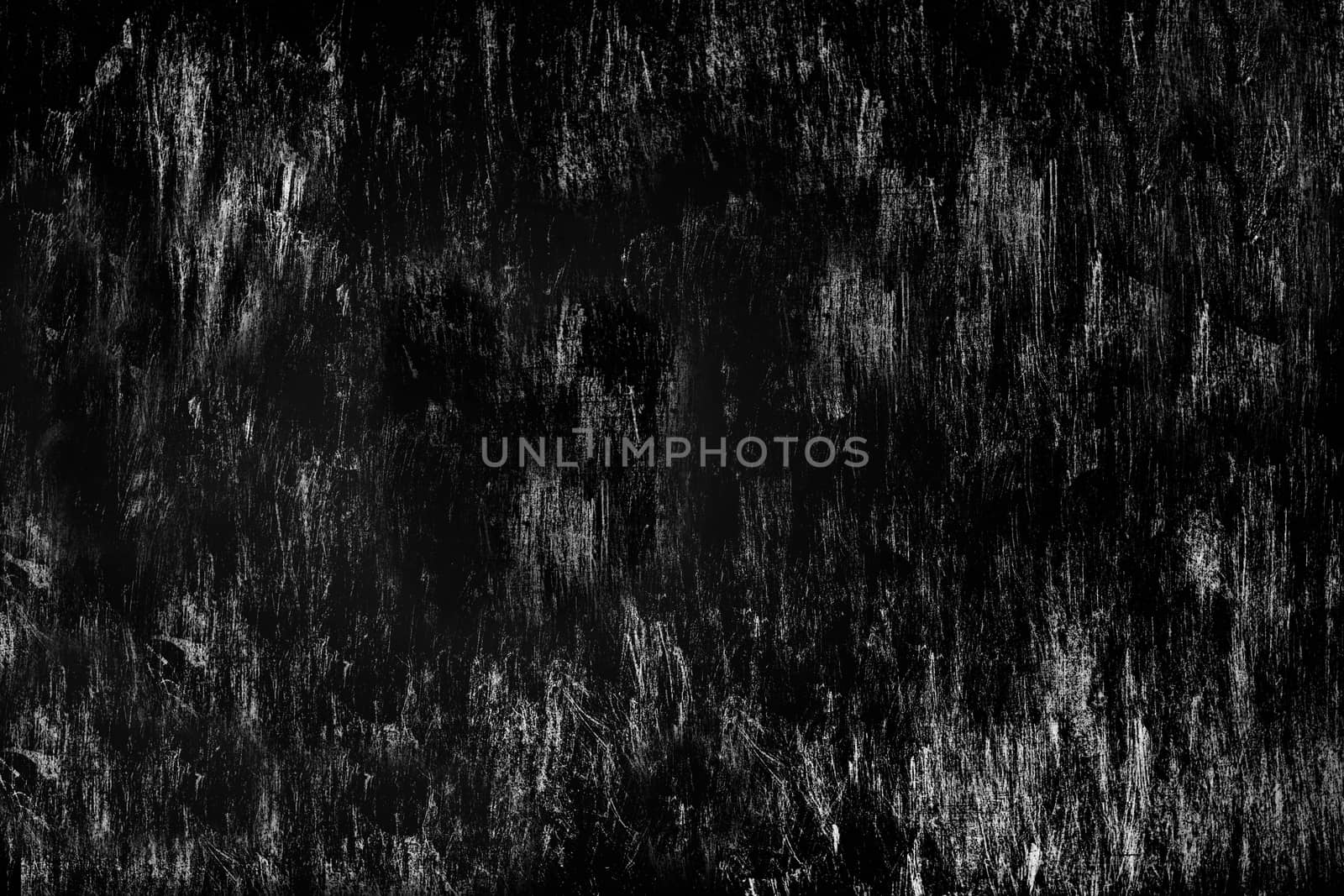 Heavily scratched surface of the stone wall aged by time black color. Texture or background