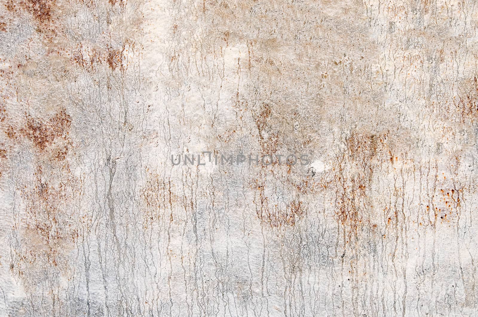 Rusty metal surface with peeling white paint on it