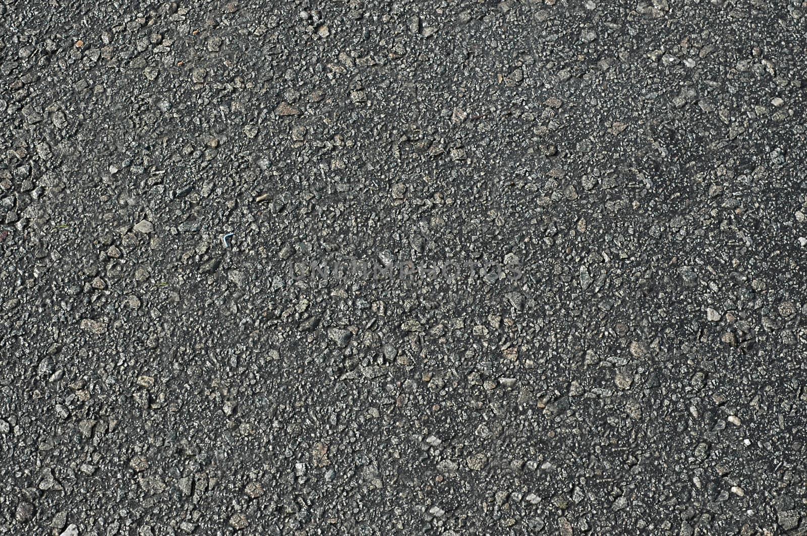 Asphalt road is dark grey with a rough surface.Texture or background.