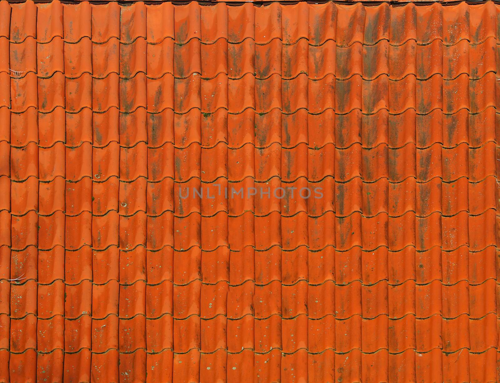 Old roof tiled orange color of old house with dirty textured surface