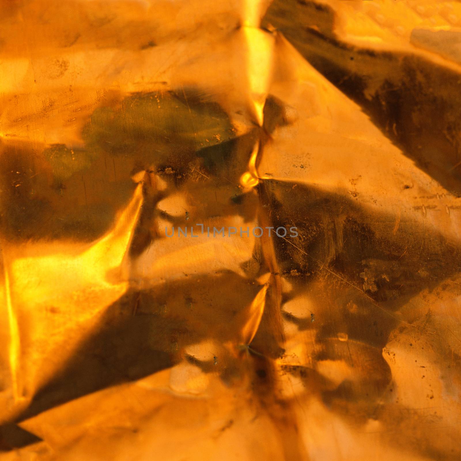 Strongly crumpled gold-colored foil.Texture or background.
