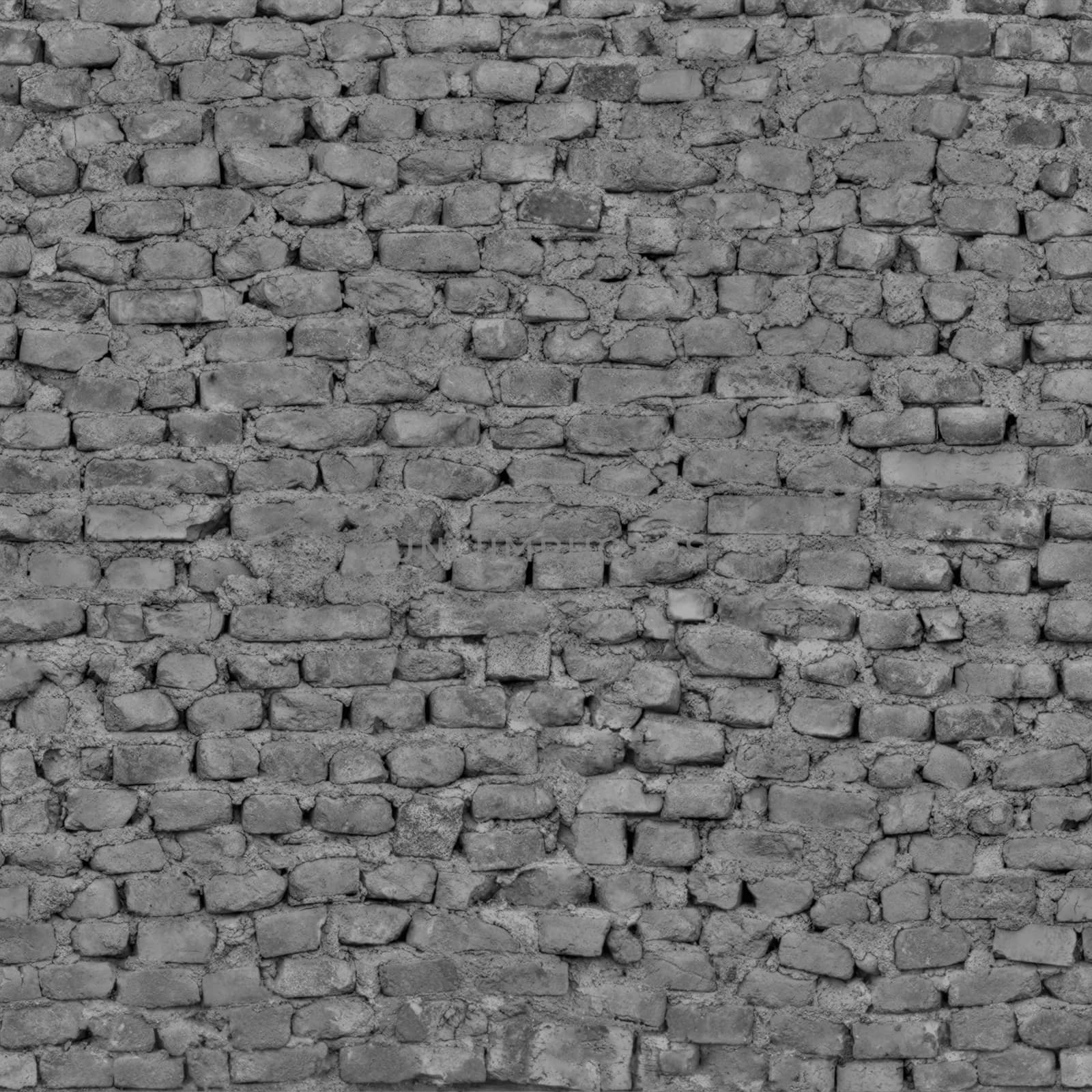 The wall of the abandoned building is made of dark gray bricks .Texture or background