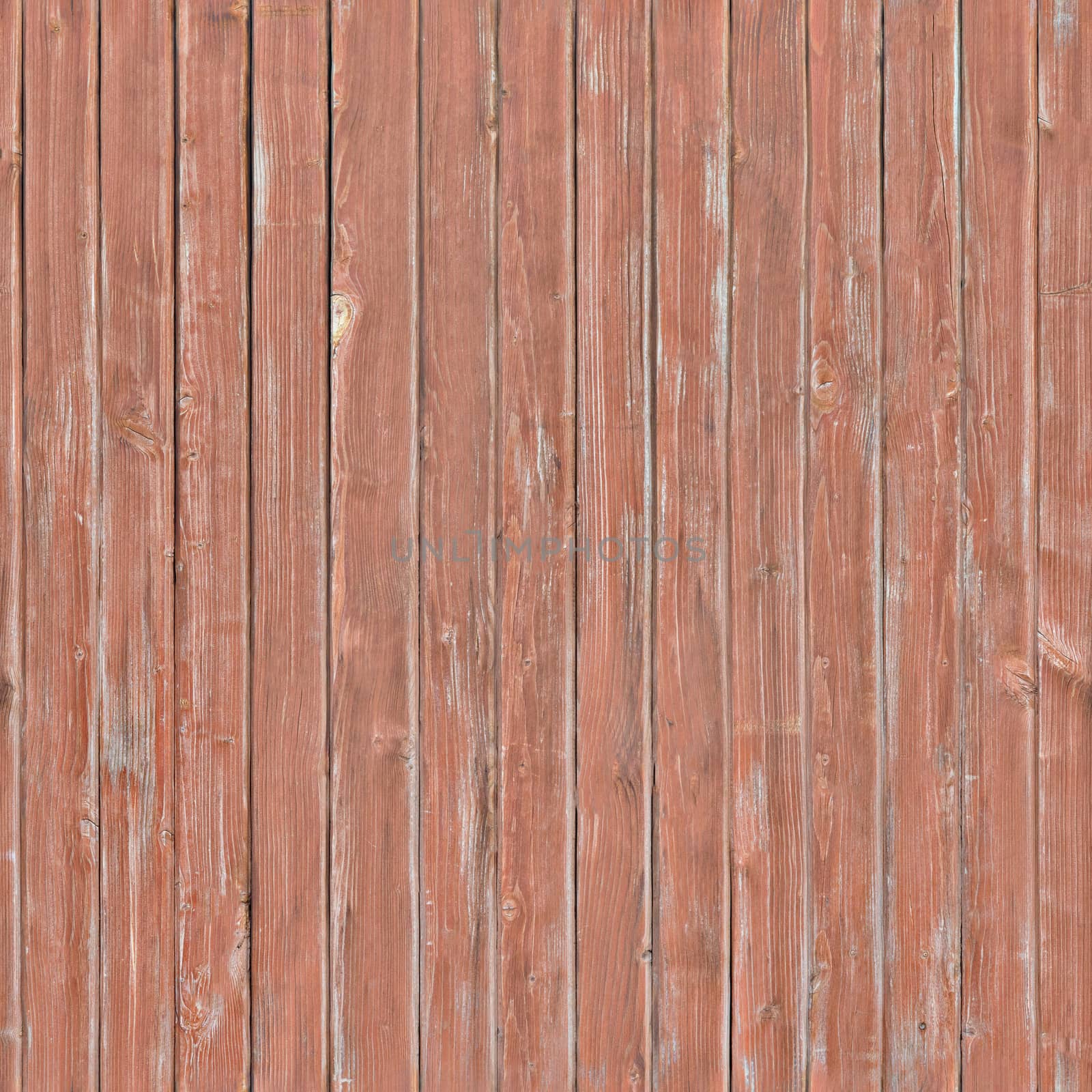 Outdated fence boards with peeling red paint on it.Background or texture