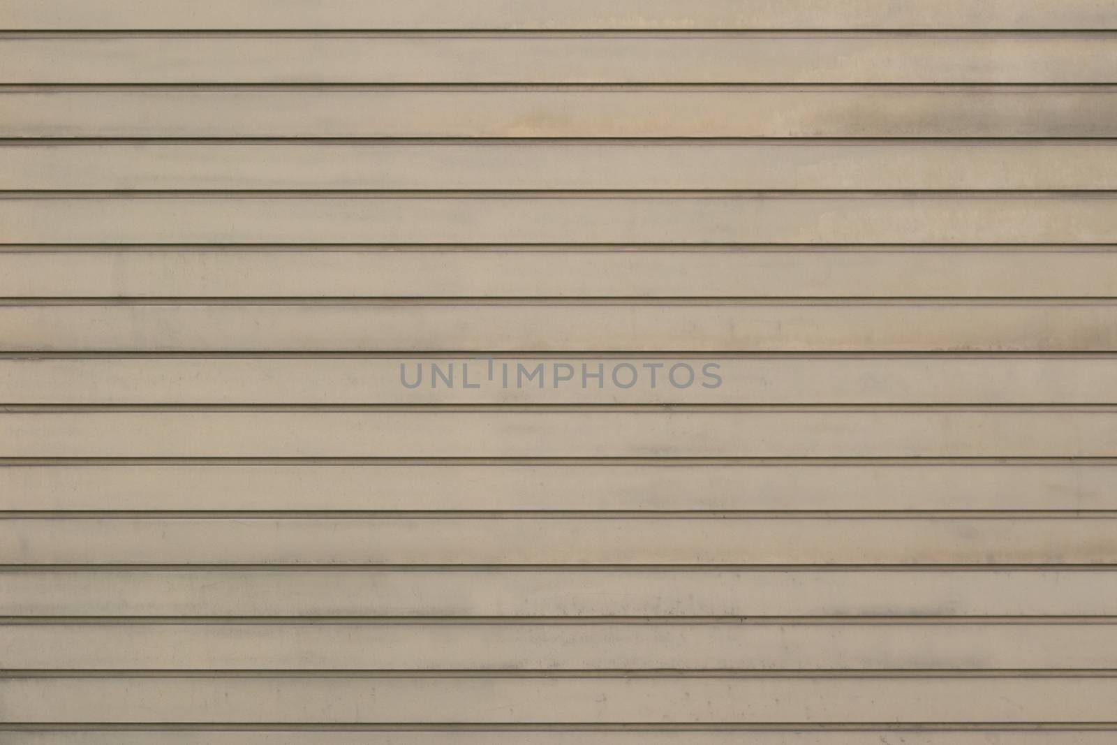 The facade of the house is laid out horizontally boards beige gray.Texture or background