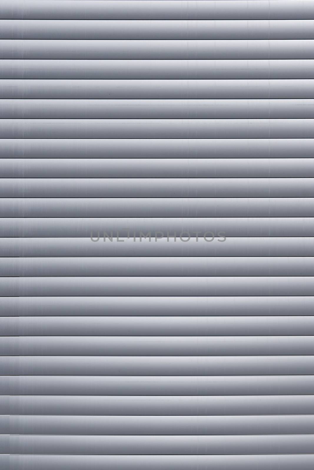 The window has horizontal gray blinds. Texture or background