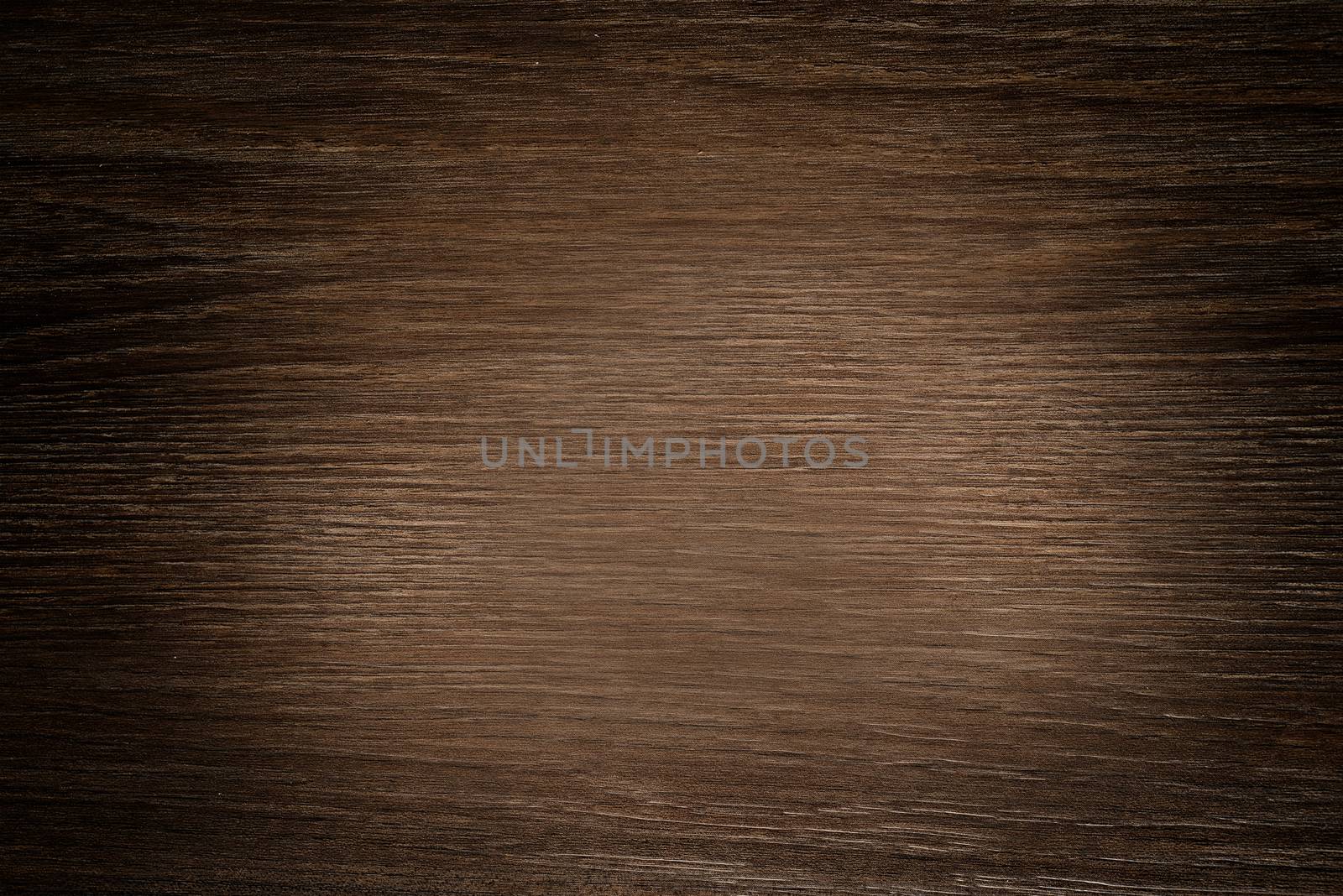 The wooden Board is dark brown with a rough texture and a lightening shade in the middle.Texture or background