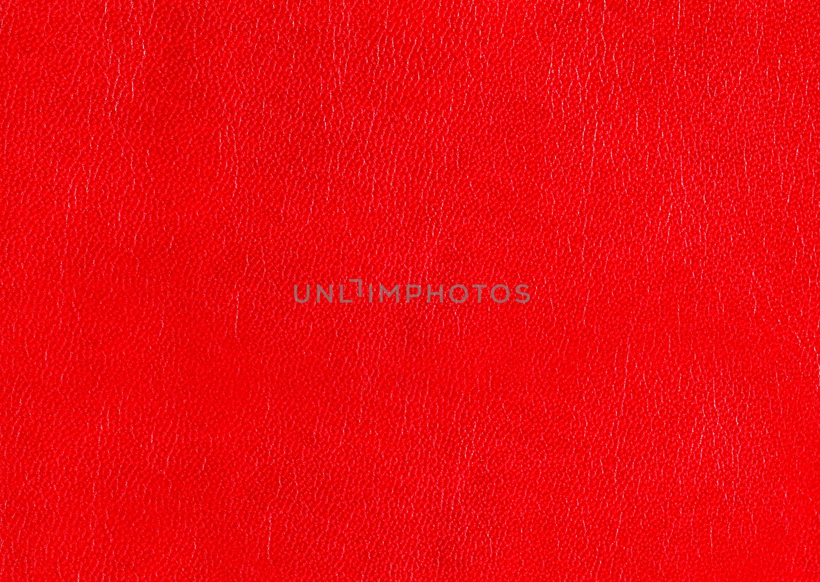 Natural red leather for upholstery with rough textured surface.Texture or background