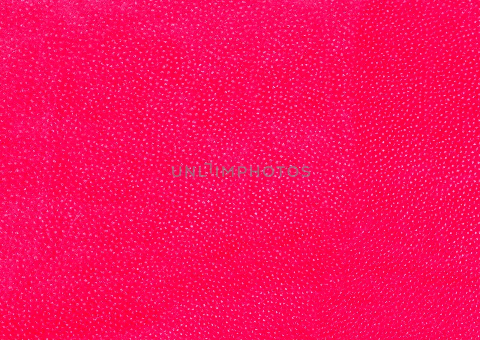 Red wall with numerous white spots on the surface .Texture or background