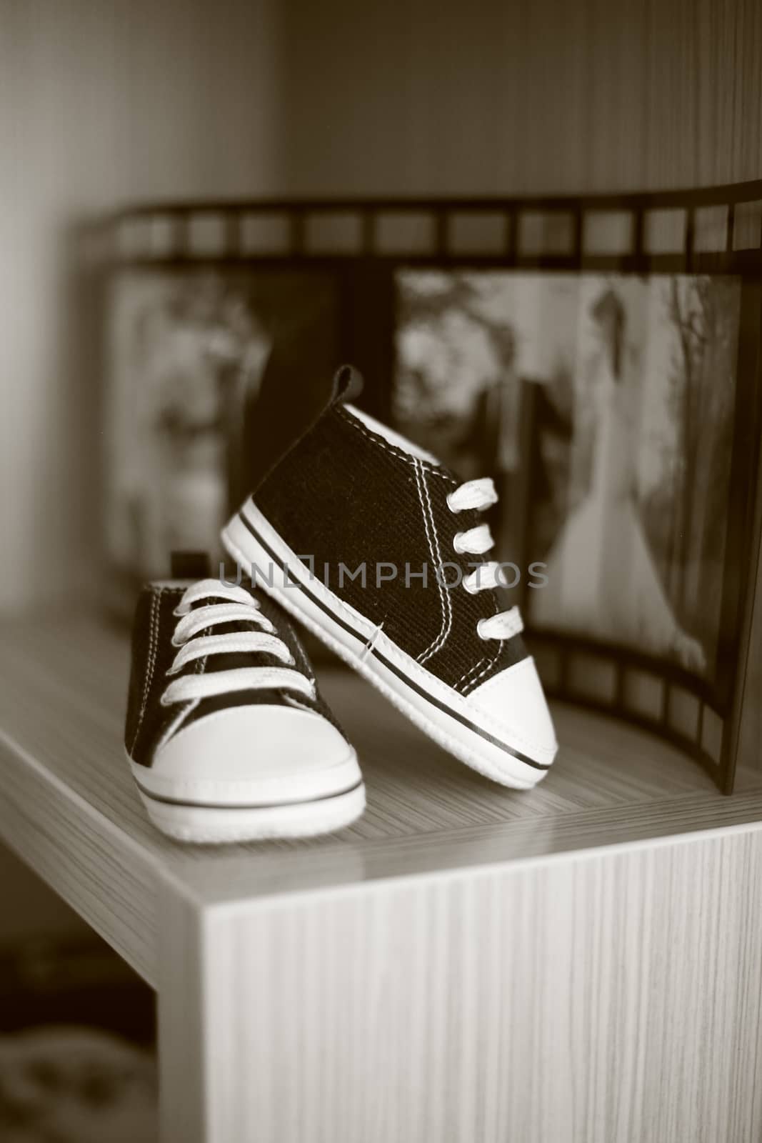 Black and white photo of very small children's sneakers