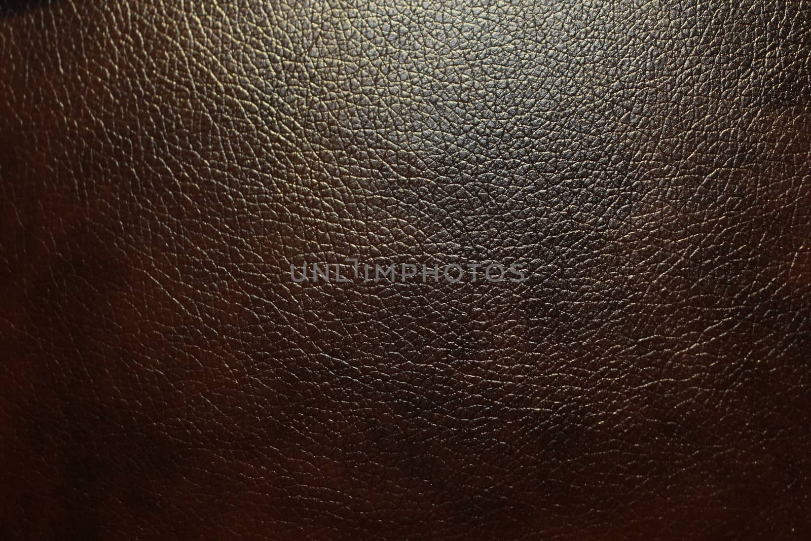 Abstract dark brown faux leather with a rough textured surface