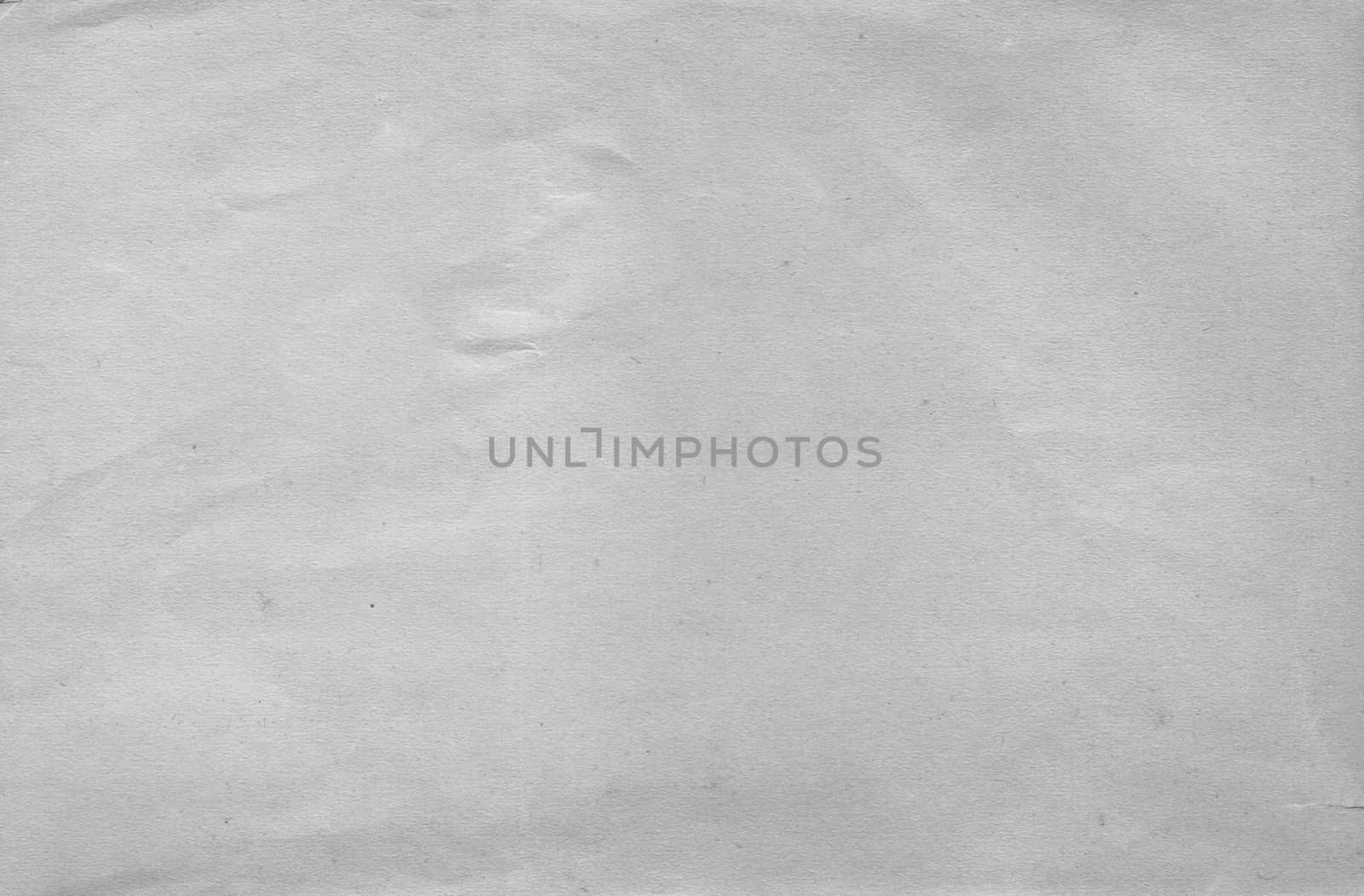 A sheet of white paper with a crumpled surface