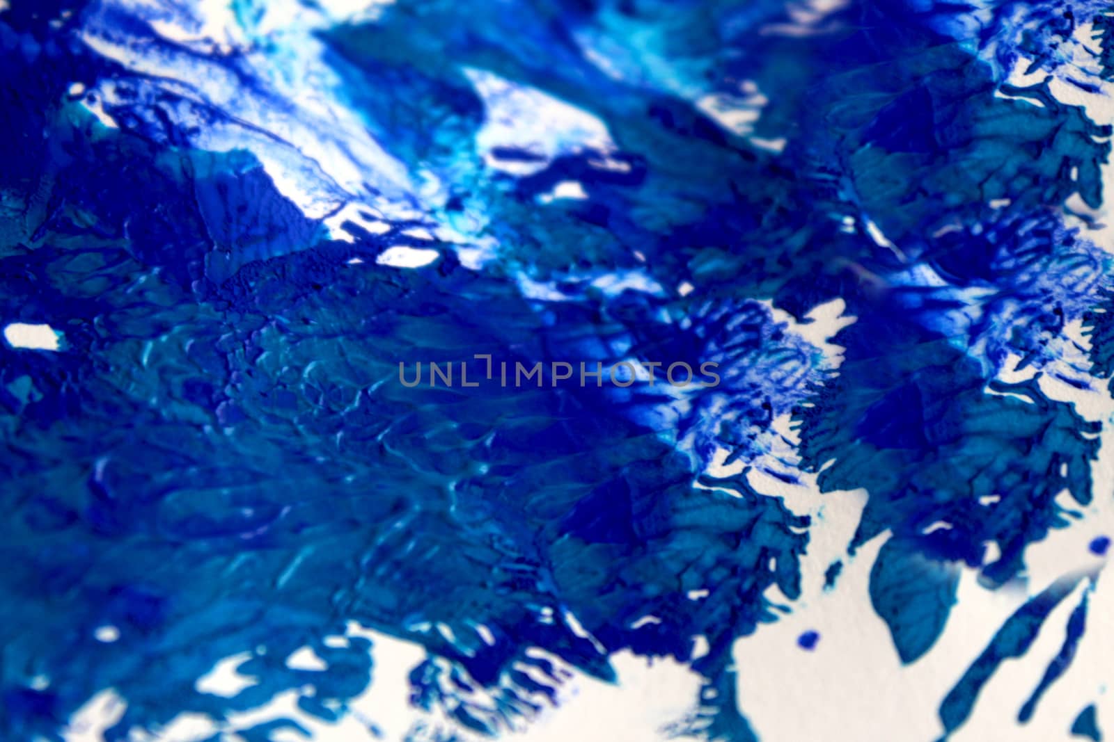 Smeared blue paint on white paper background or texture