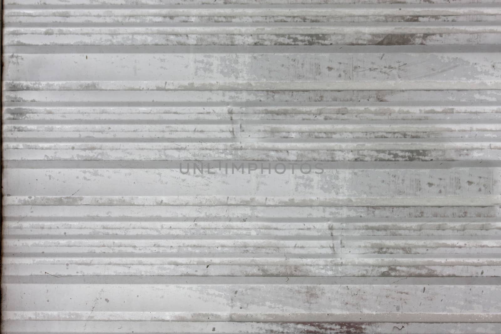 Old dark grey metal plate with horizontal stripes