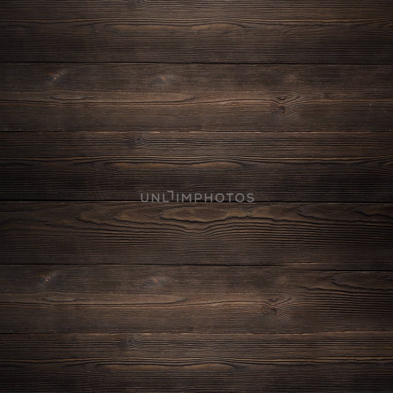 The texture of the wooden walls of the old house a dark color