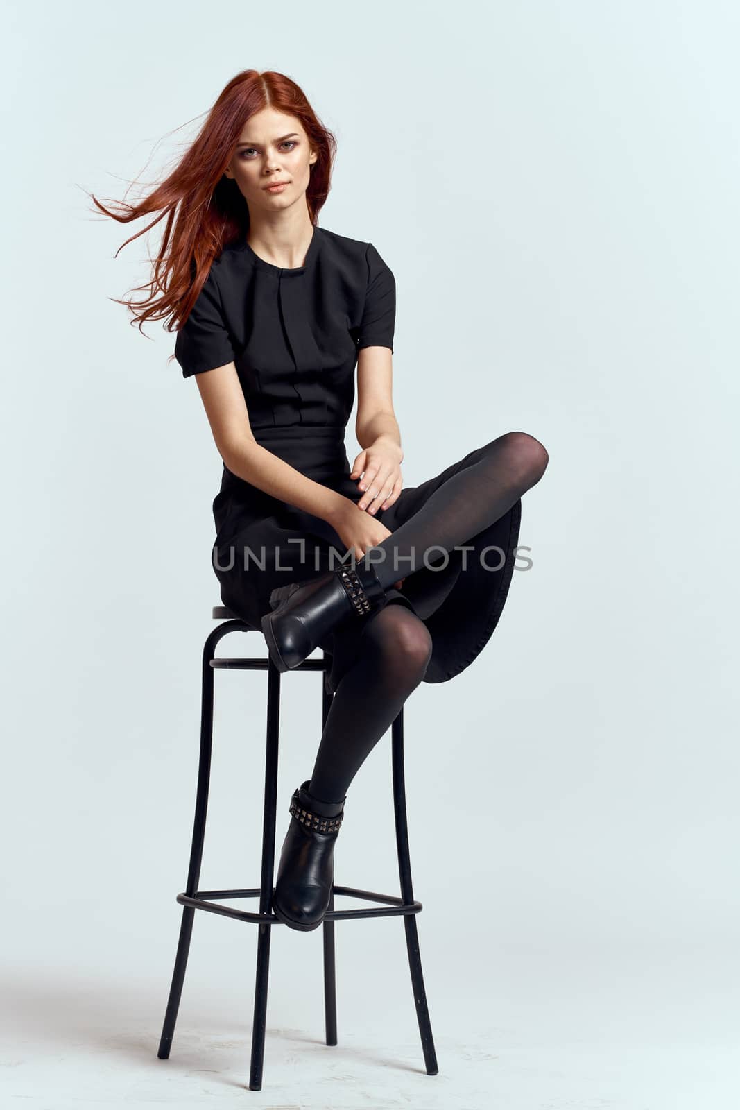 woman high chair indoors full length black dress red hair model boots by SHOTPRIME