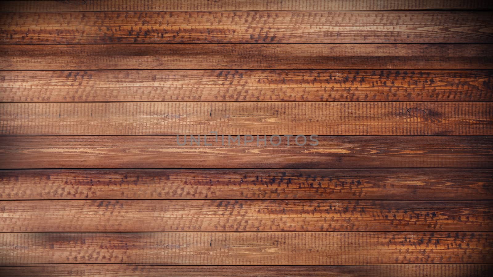 A brown wooden Board is laid out horizontally .Texture or background