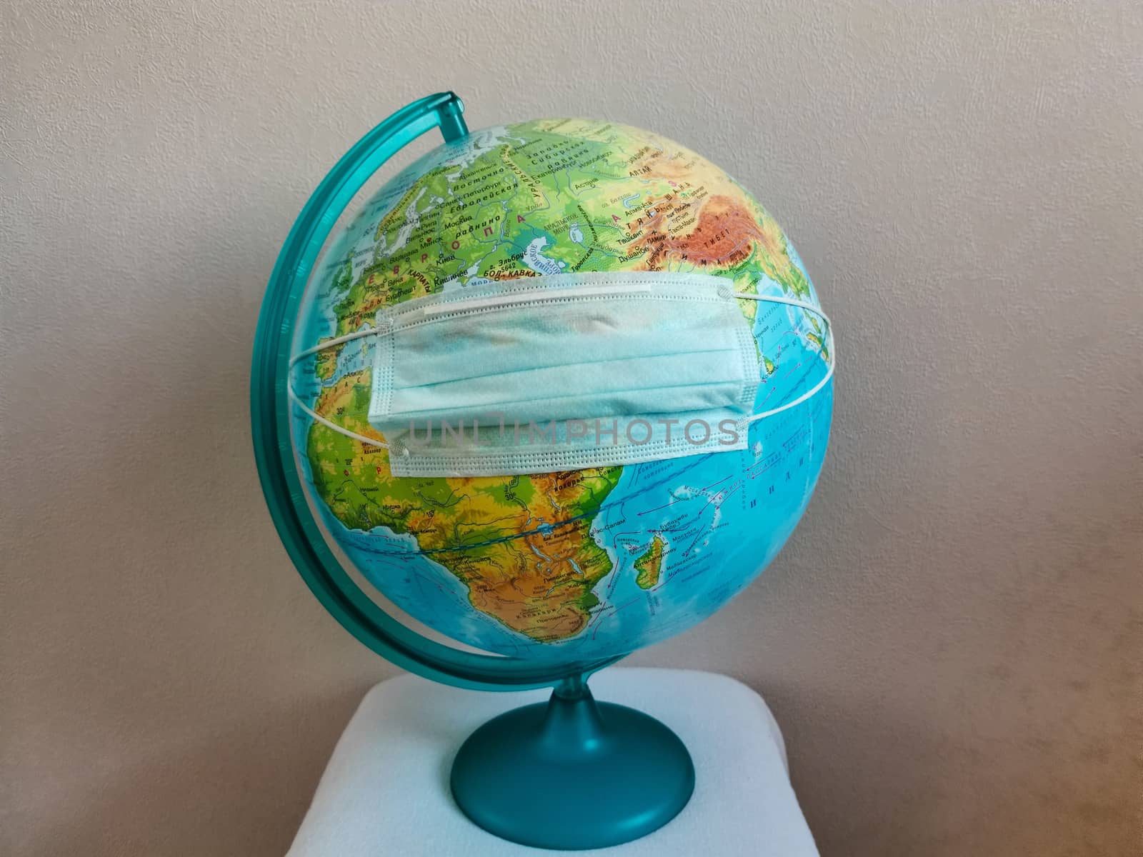 The globe of the planet earth is wearing a disinfecting face mask.Texture or background